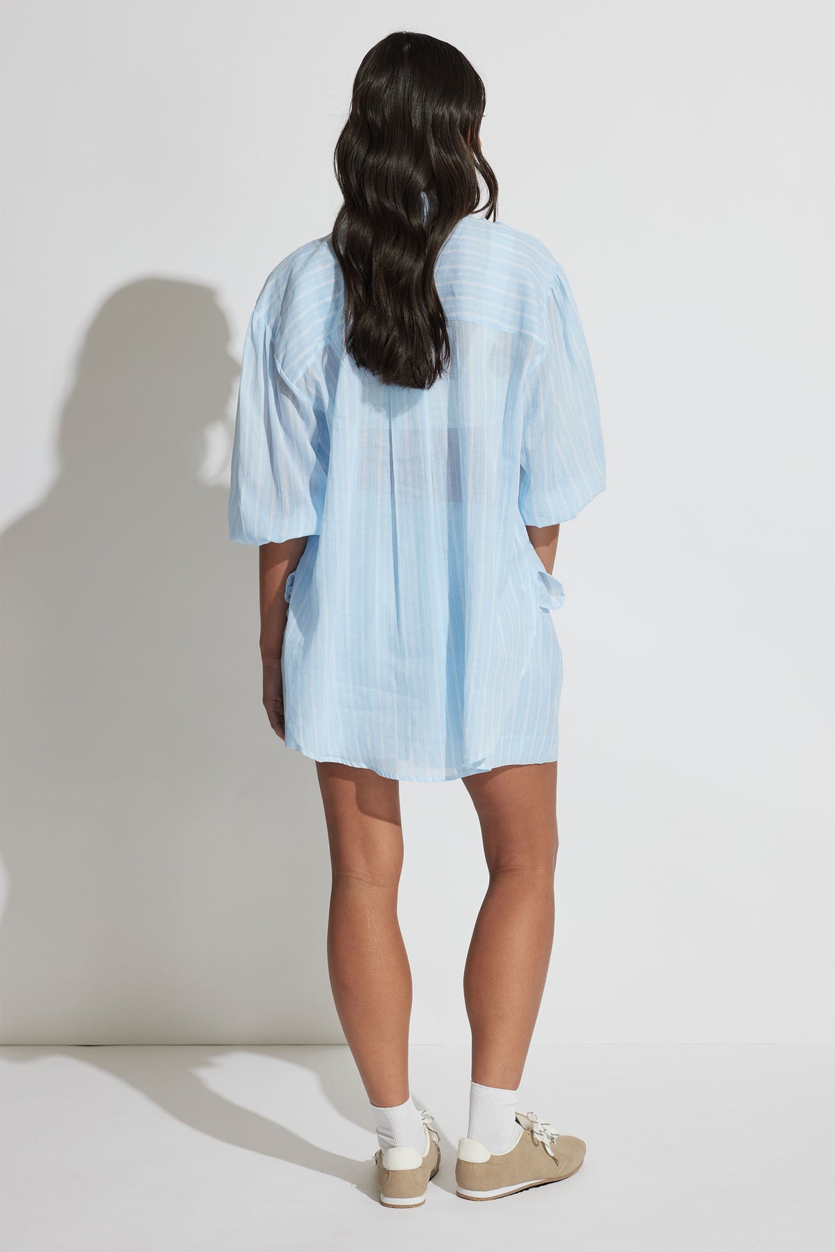 Model wearing Brooke Ramie Short in portrait gallery shot three, showing back view with relaxed fit and light fabric texture
