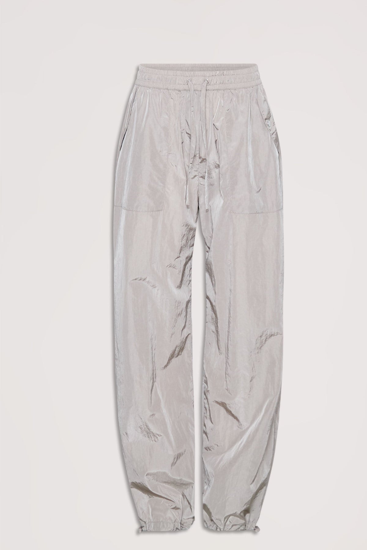Light gray parachute-style jogger pants with elastic waistband, drawstring ties, and slip pockets, laid flat on white background.