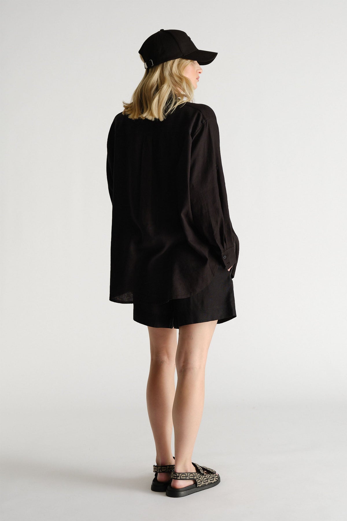 D-Luxe Linen Blend Short worn in gallery image 3, portrait view, showing lightweight breathable linen design from back.