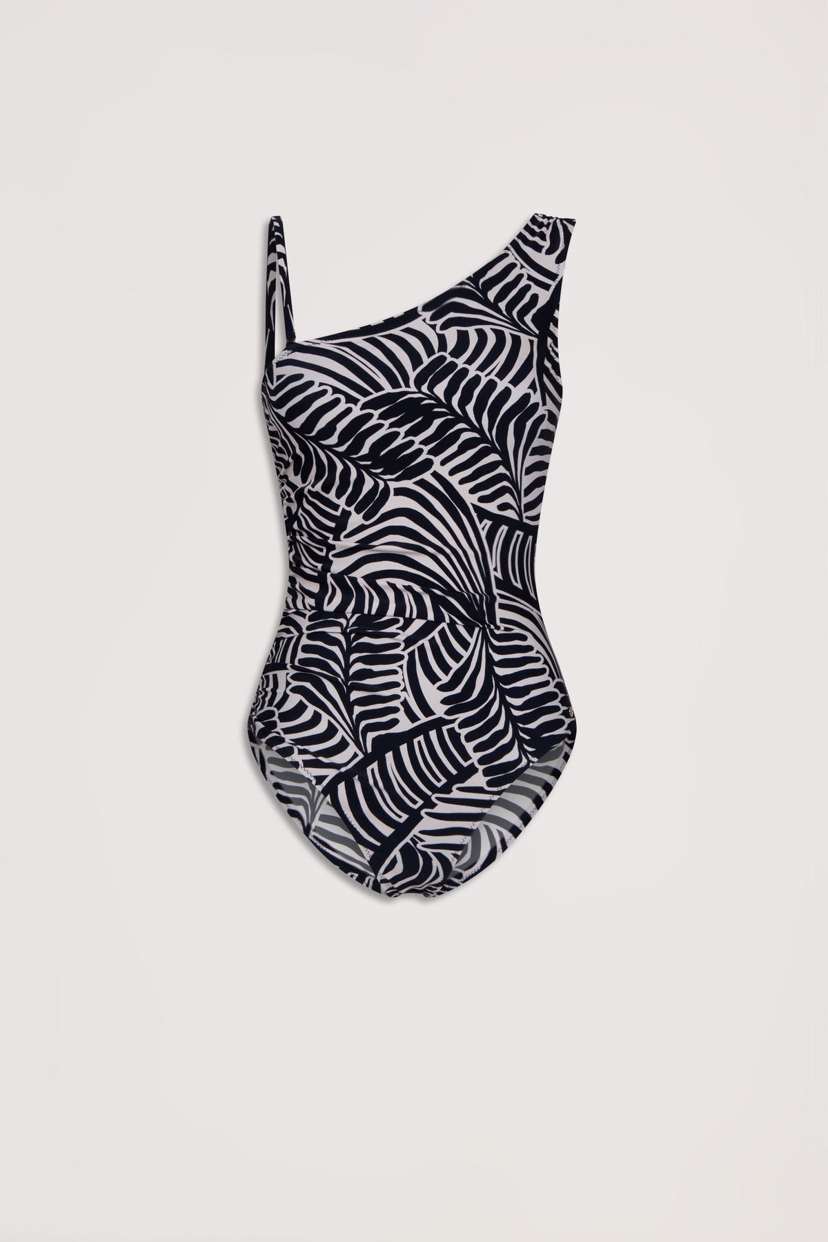 Black and white matte one-shoulder swimsuit with a bold abstract palm leaf pattern on a light background