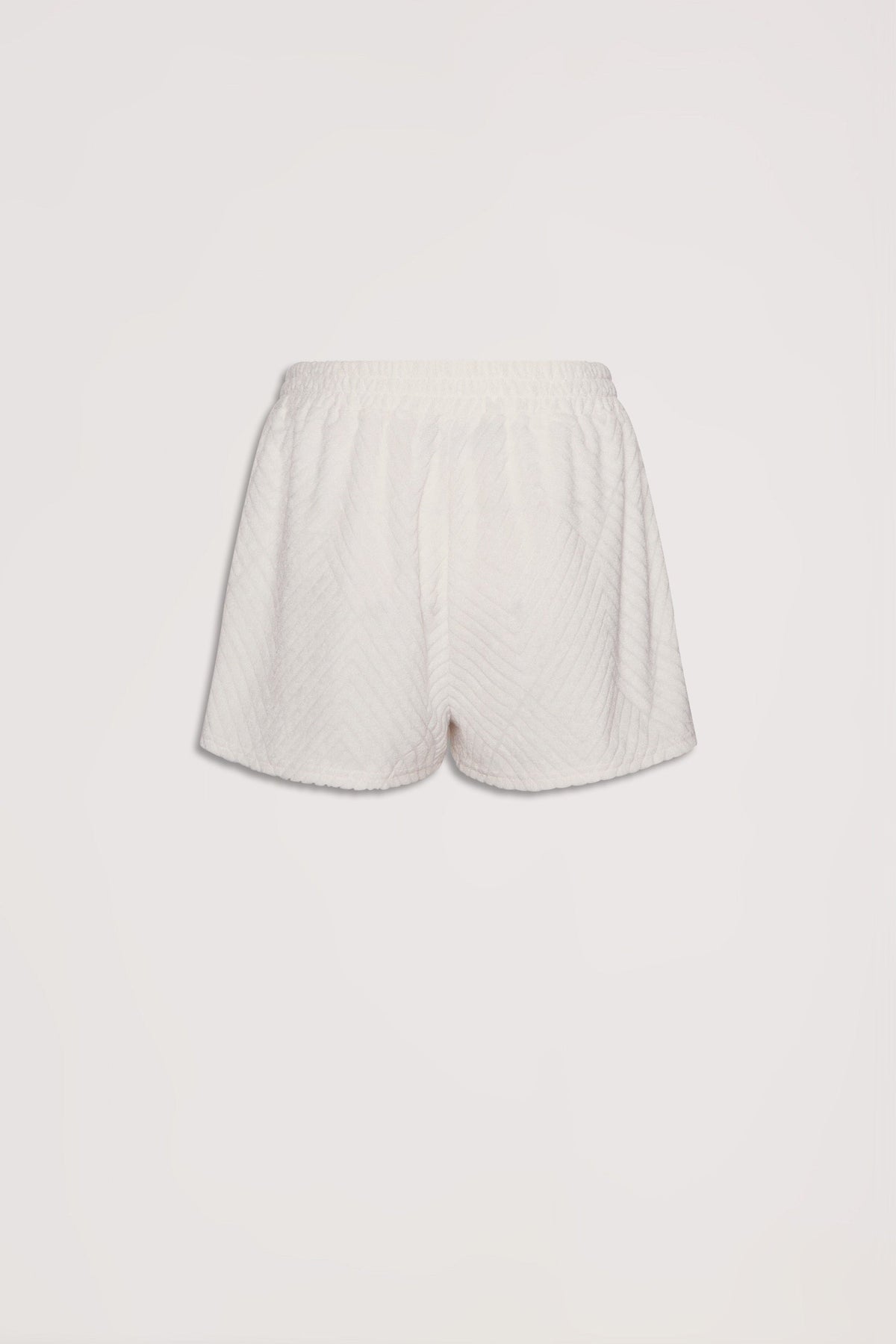 Soft textured cream terry shorts with elastic waistband, offering a relaxed and comfortable fit for everyday wear