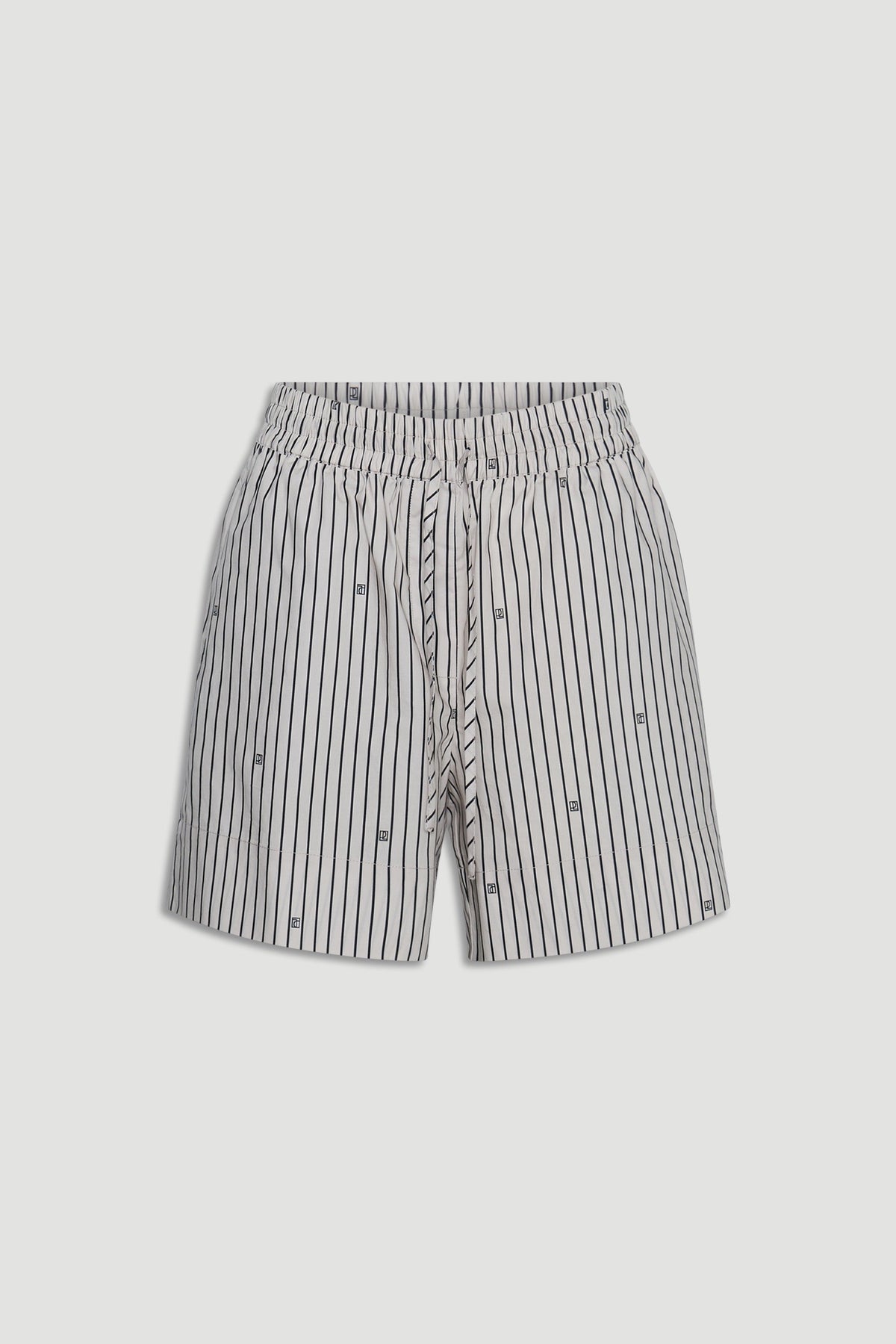 Light-colored shorts with vertical black stripes and subtle monogram details, featuring a drawstring waist for comfort.