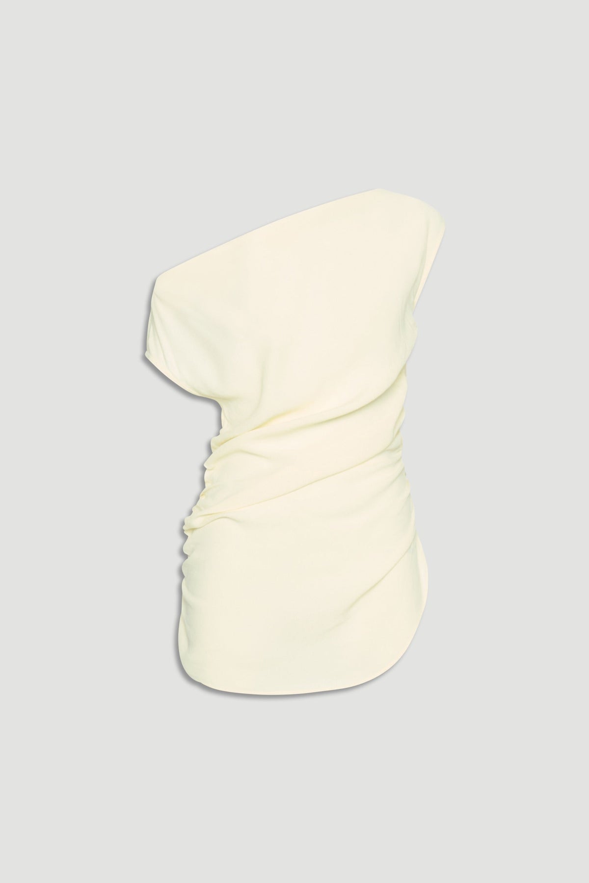 Cream one-shoulder top with a ruched side detail, offering a sleek and elegant silhouette.