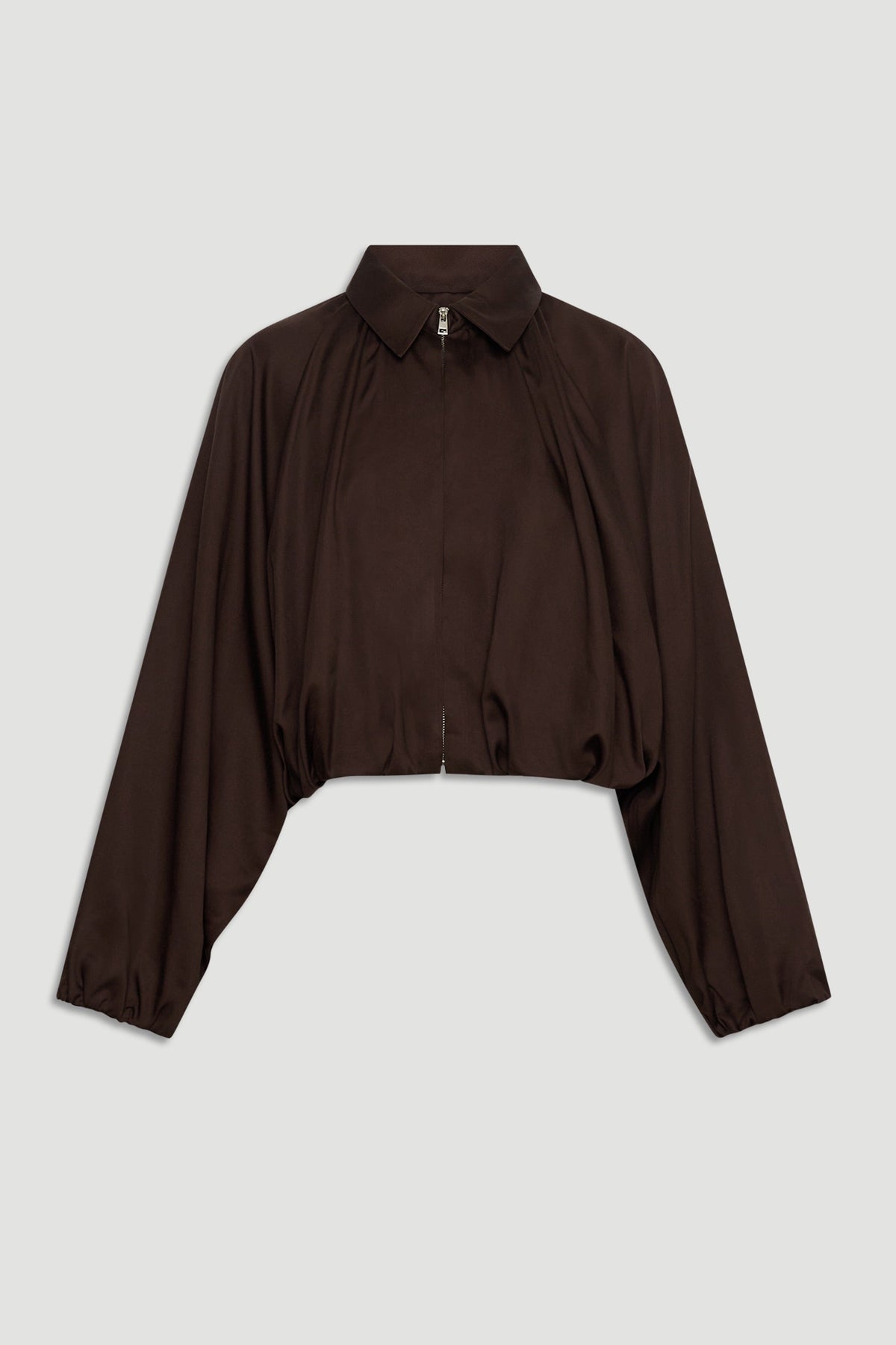 Dark espresso cropped jacket with puffed long sleeves, a collar, and a front zipper for a chic, modern silhouette