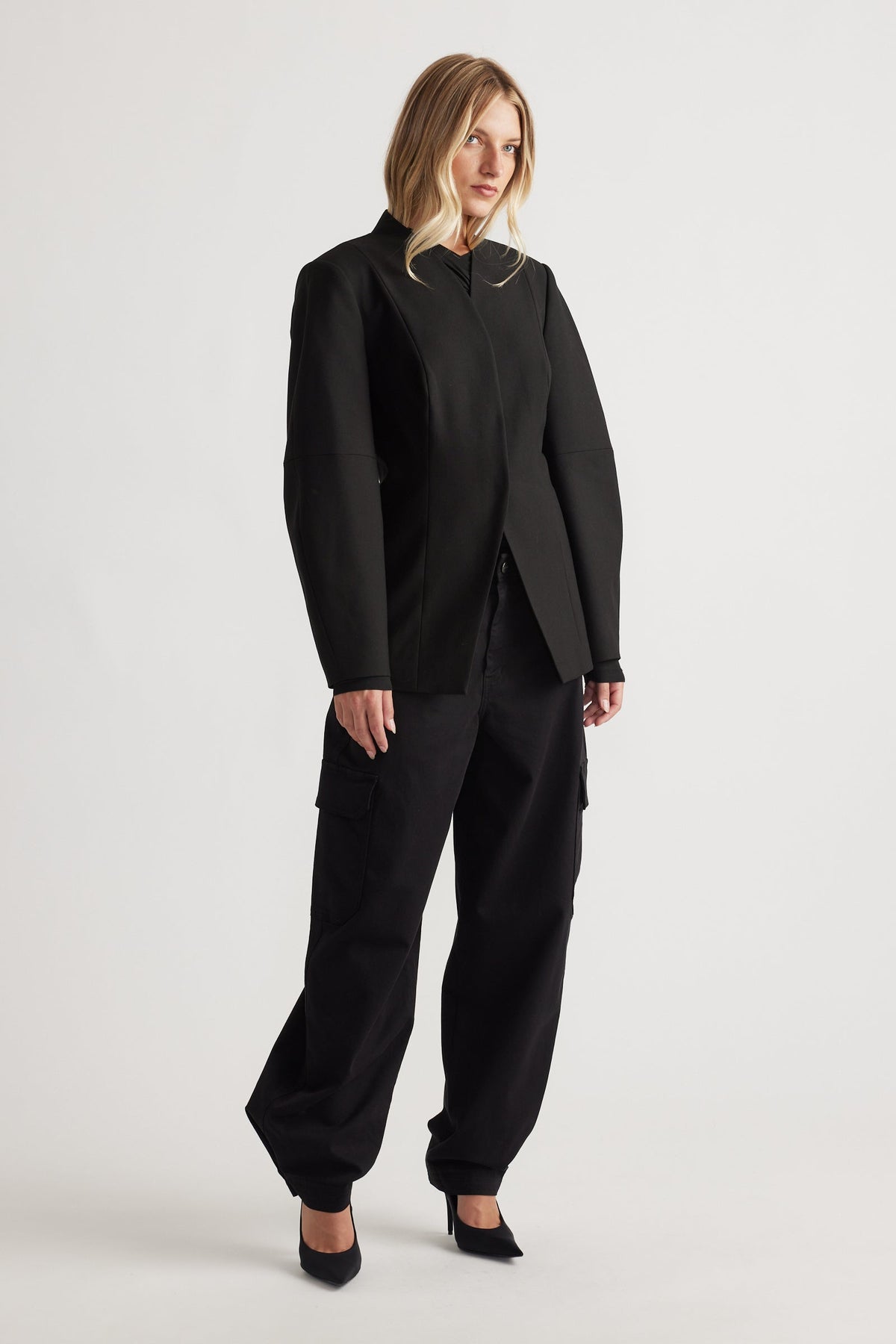 Model wearing black Peyton Zip Cargo Pocket Pant with relaxed fit, side cargo pockets, and cuffed hems for versatile, modern style.