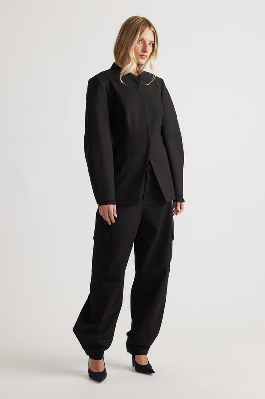 Model wearing black Peyton Zip Cargo Pocket Pant with relaxed fit, side cargo pockets, and cuffed hems for versatile, modern style.