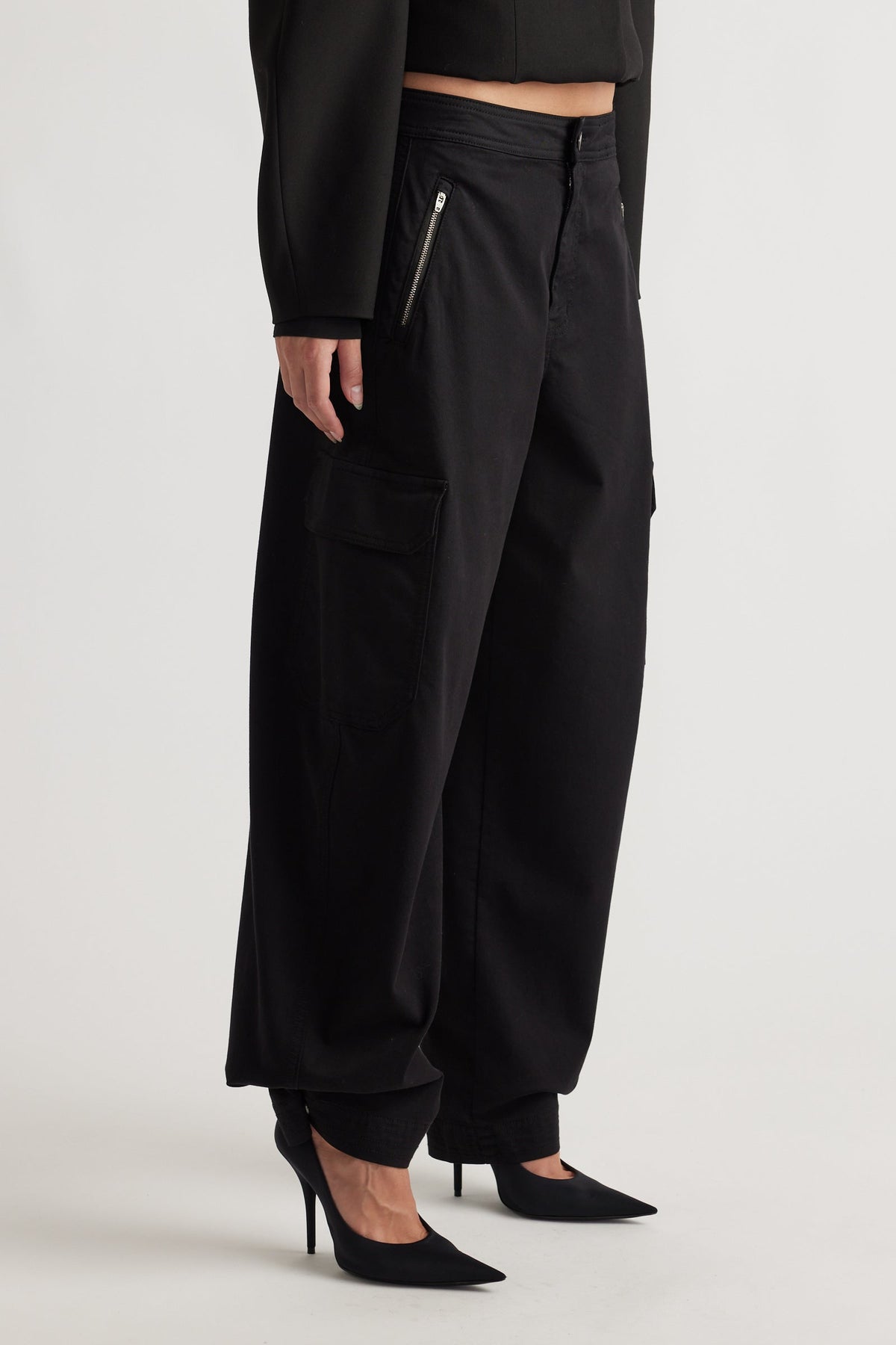 Black Peyton Zip Cargo Pocket Pant with relaxed fit, zippered side pockets, and cuffed hems for modern street style by DECJUBA.