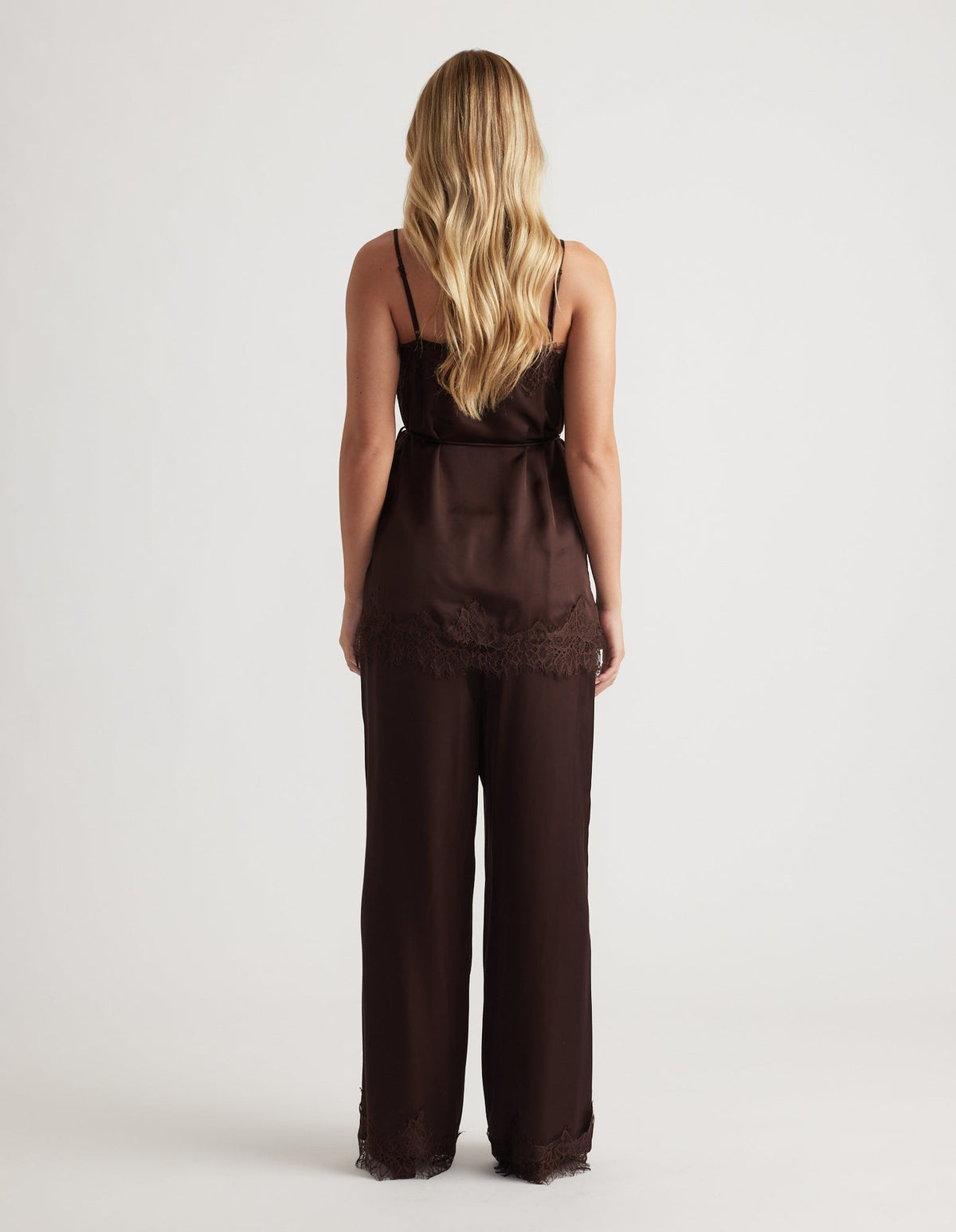 Back view of a rich mocha silky camisole with delicate lace trim paired with matching wide-leg pants
