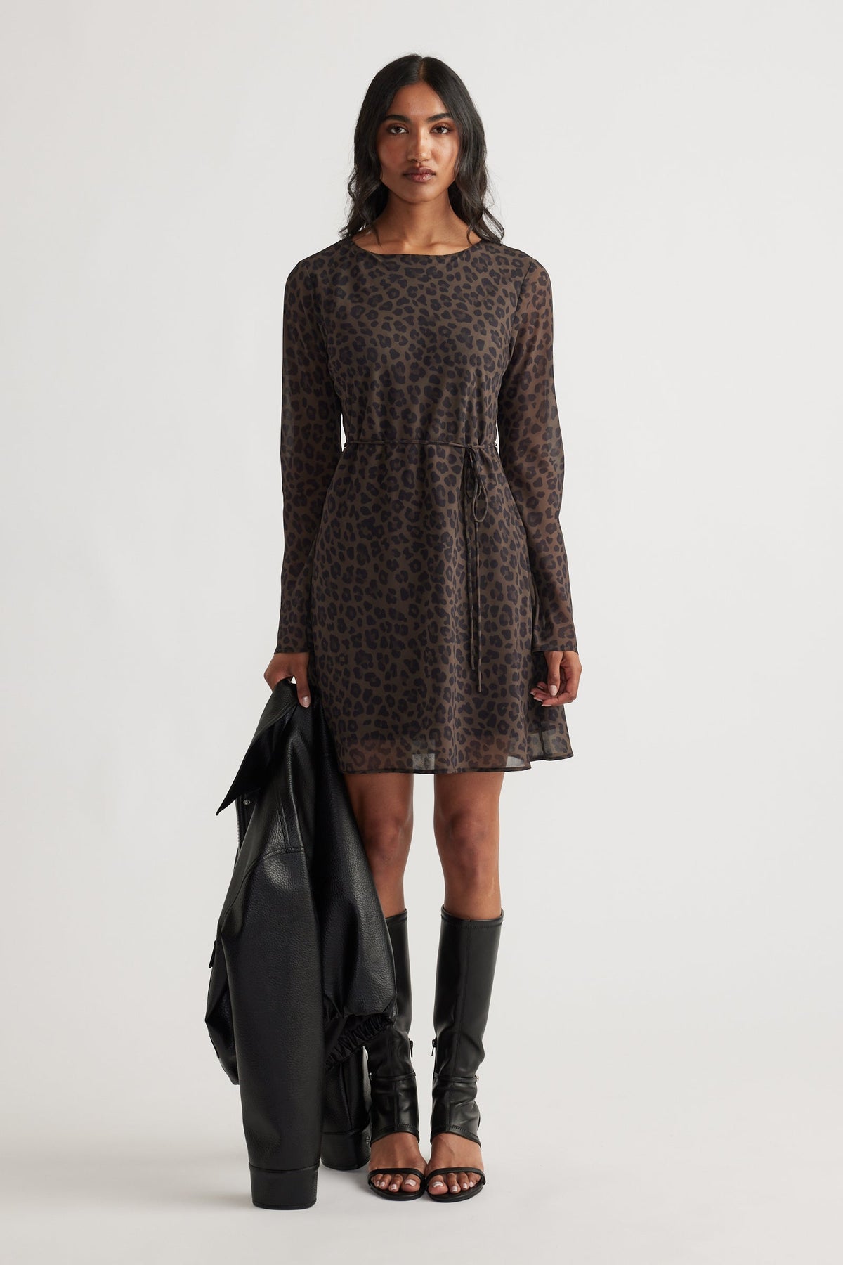 Chelsea Georgette Mini Dress in dark animal print with long sleeves, relaxed waist, styled with black boots and jacket by DECJUBA