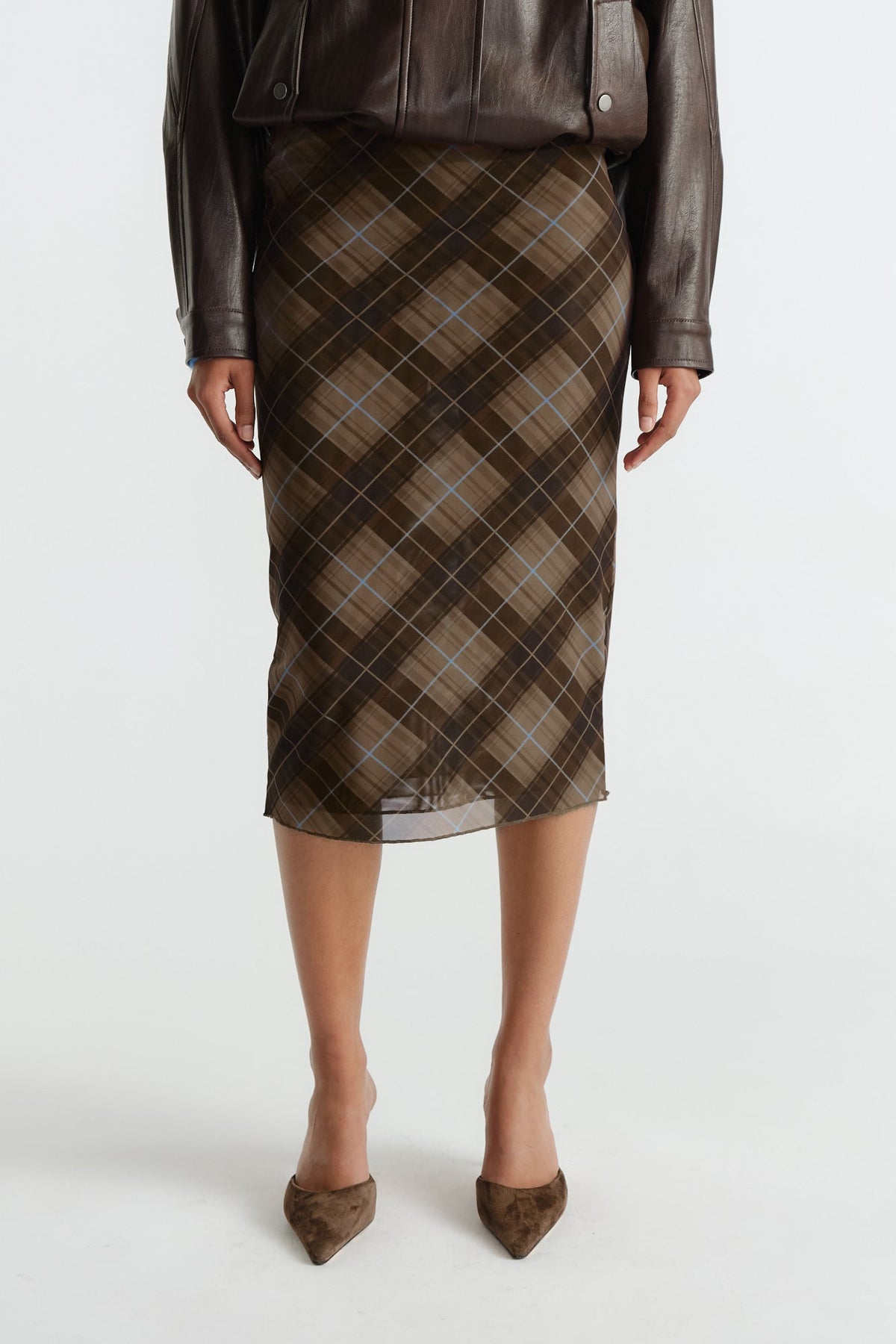 Knee-length mesh skirt in caramel and brown plaid with subtle blue lines, styled with a dark brown leather jacket.