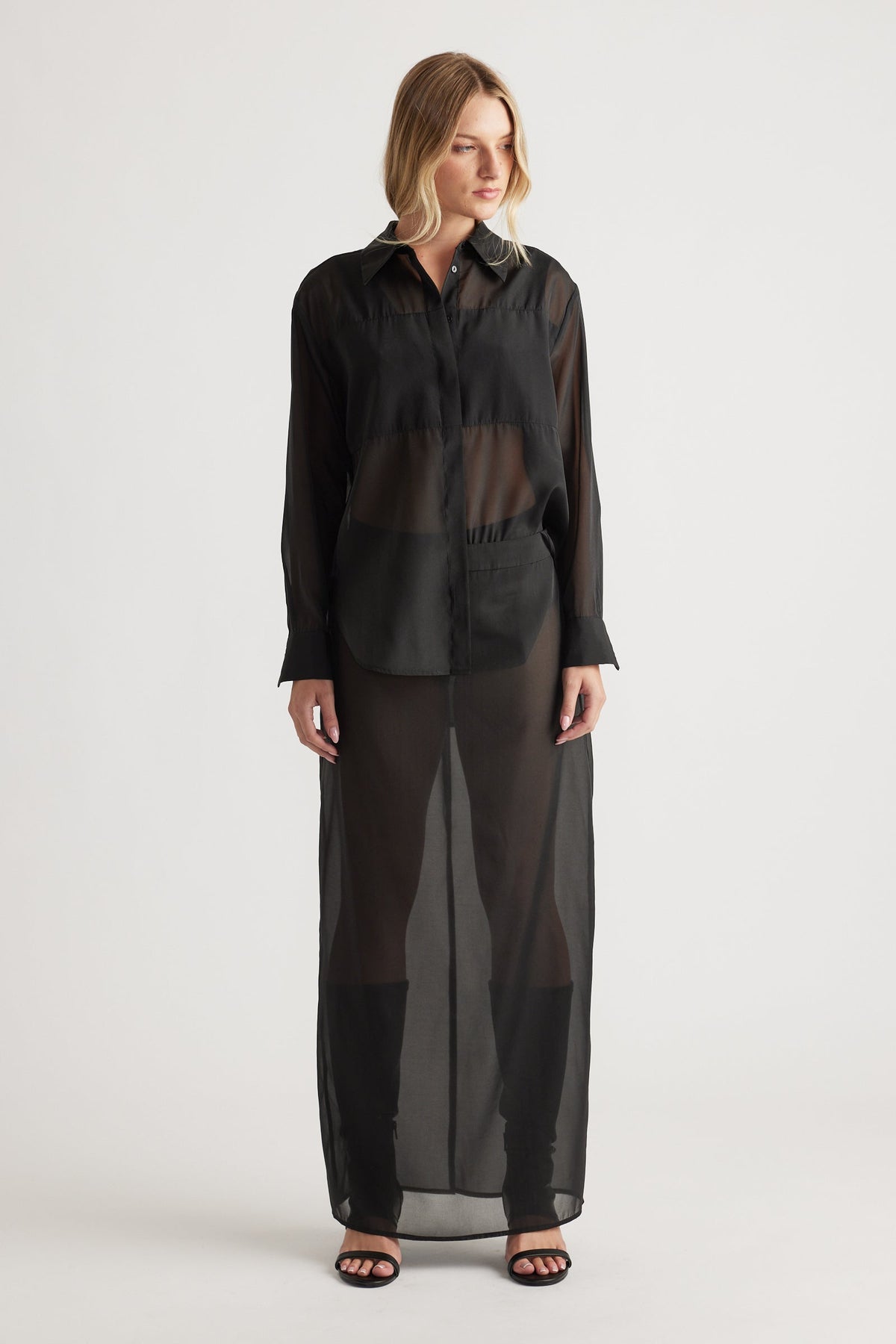 Front view of a black sheer organza long shirt with a classic collar, long sleeves, and a flowing silhouette