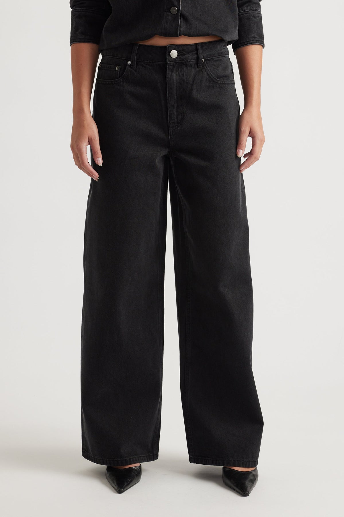 Front view of Elena Wide Leg Jean in black denim styled with cropped black top and pointed black shoes