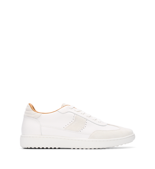 A white leather and suede sneaker with a lace-up closure and a flat heel.