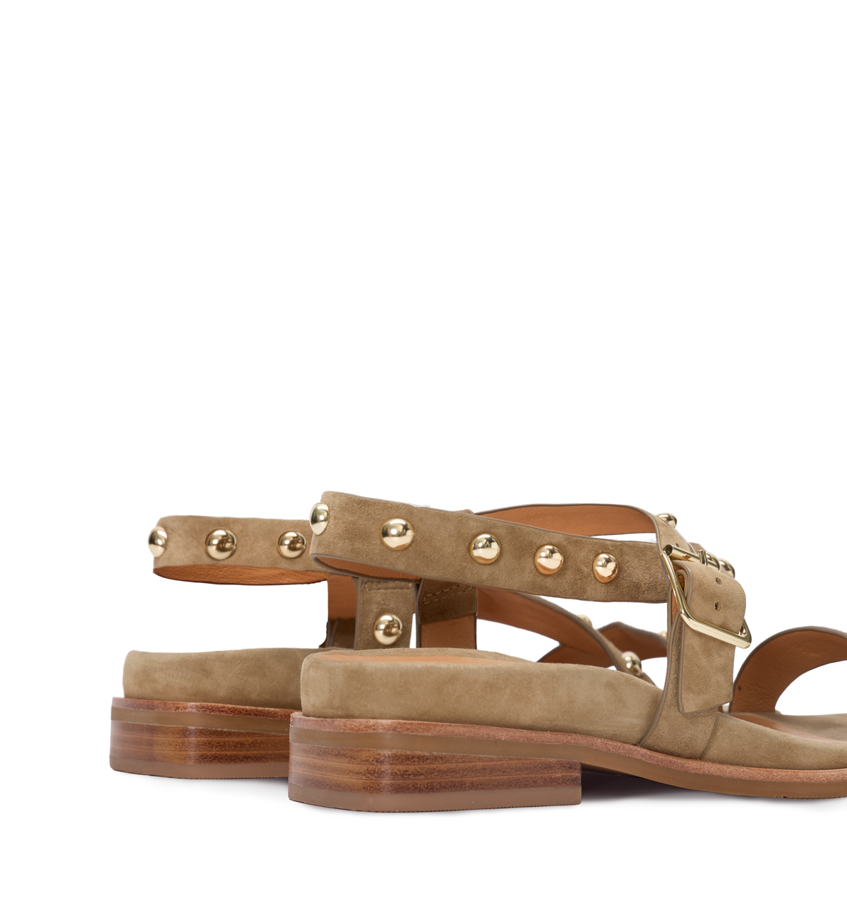 Tan suede sandals with gold studs on a white background