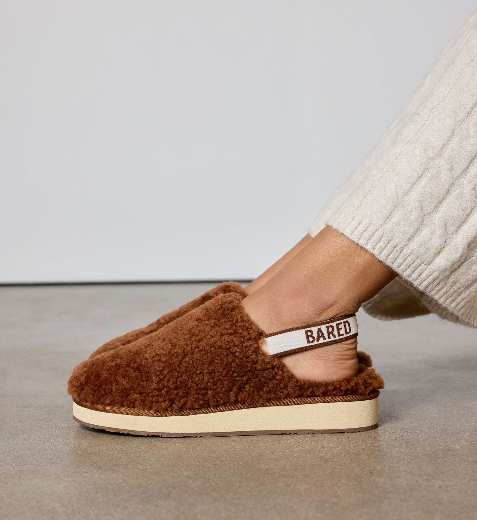 bared footwear snuggling sheepskin slingback slippers on