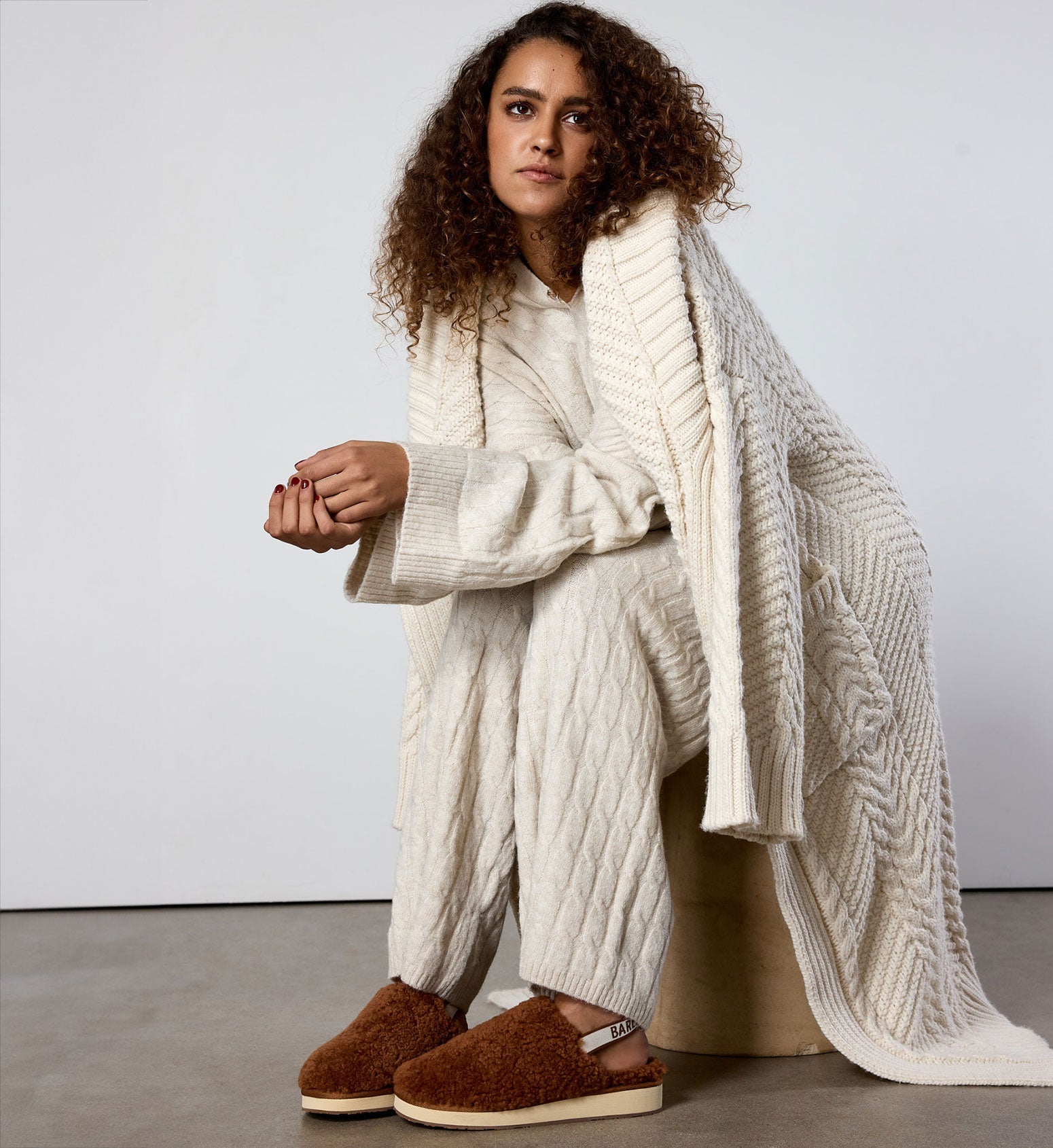 model wearing a cozy knit set and robe plus bared footwear sheepskin slippers in terracotta