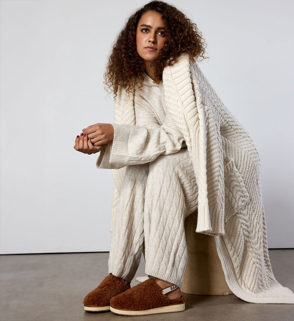 model wearing a cozy knit set and robe plus bared footwear sheepskin slippers in terracotta