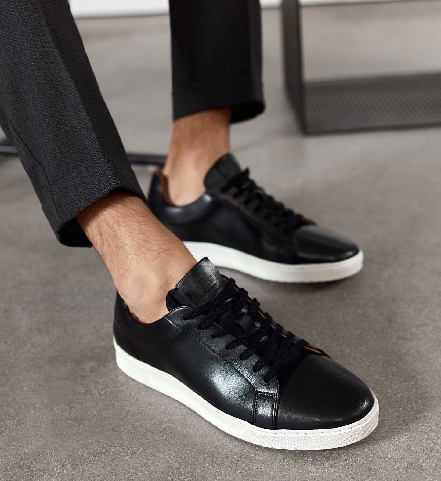 black leather sneakers for men on foot