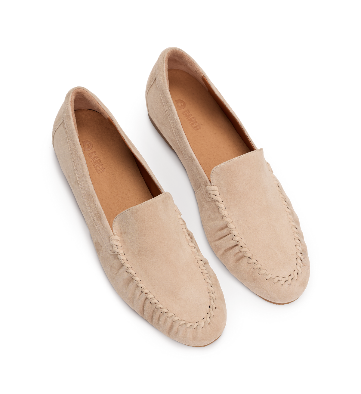 Pair of beige loafers on a white background