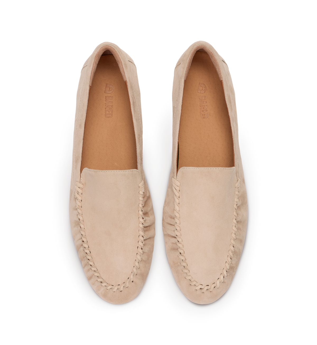 Pair of beige loafers on a white background