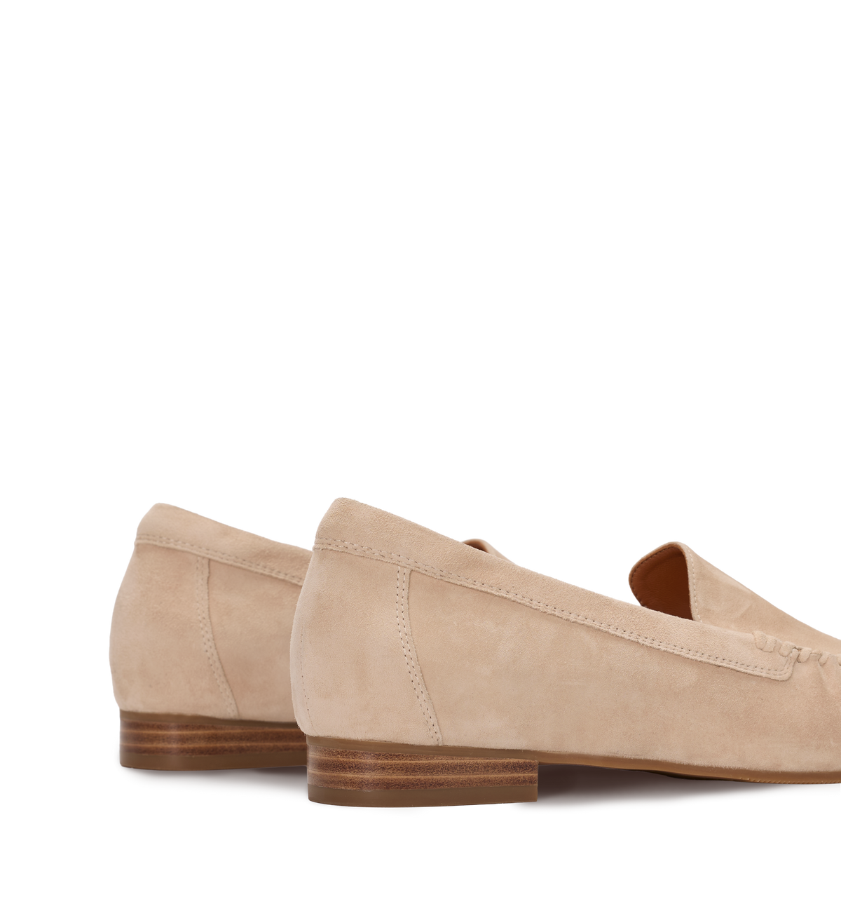 Pair of beige loafers on a white background