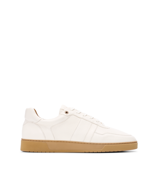 White sneaker with a brown sole on a white background