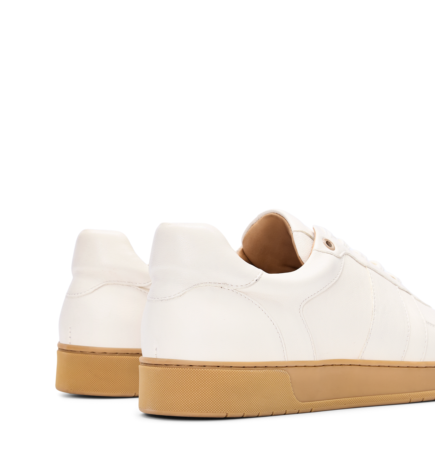 White sneakers with brown soles on a white background