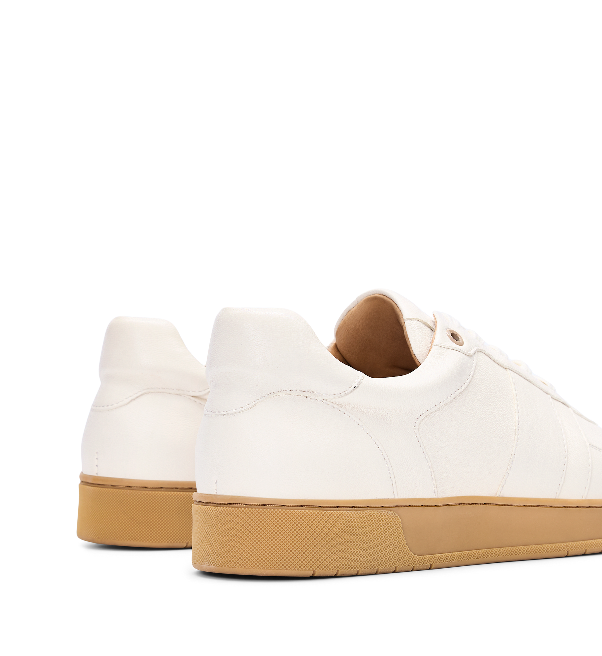 White sneakers with brown soles on a white background