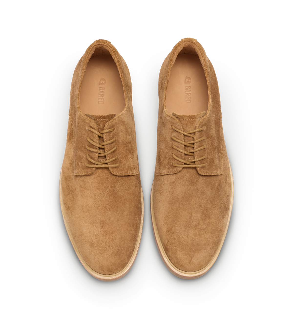 Pair of tan suede shoes on a white background