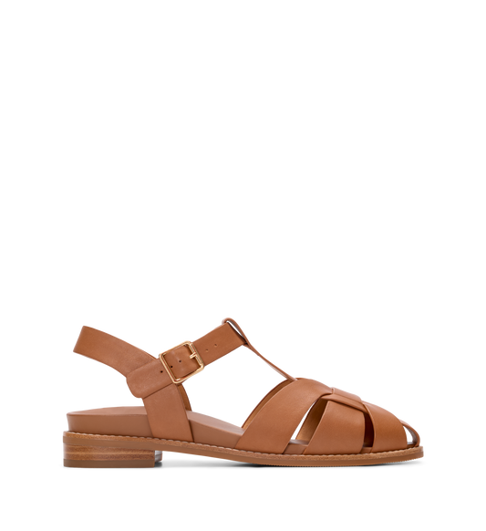 Tan sandal with criss-cross straps on a white background