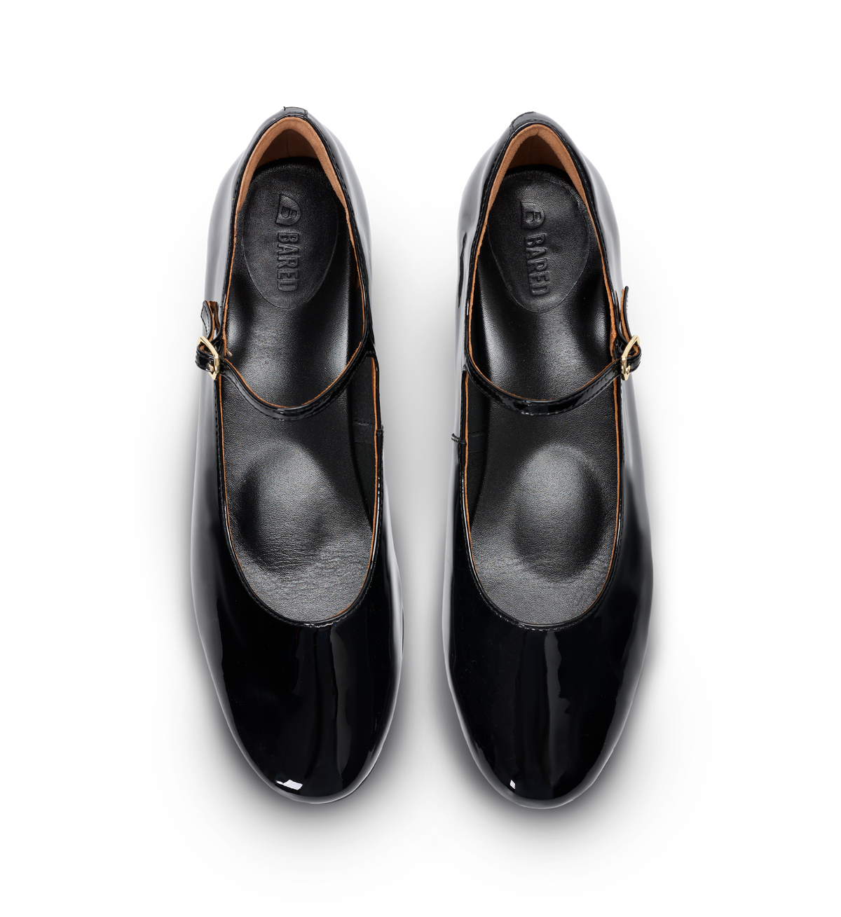 Pair of black mary janes with gold buckles on a white background