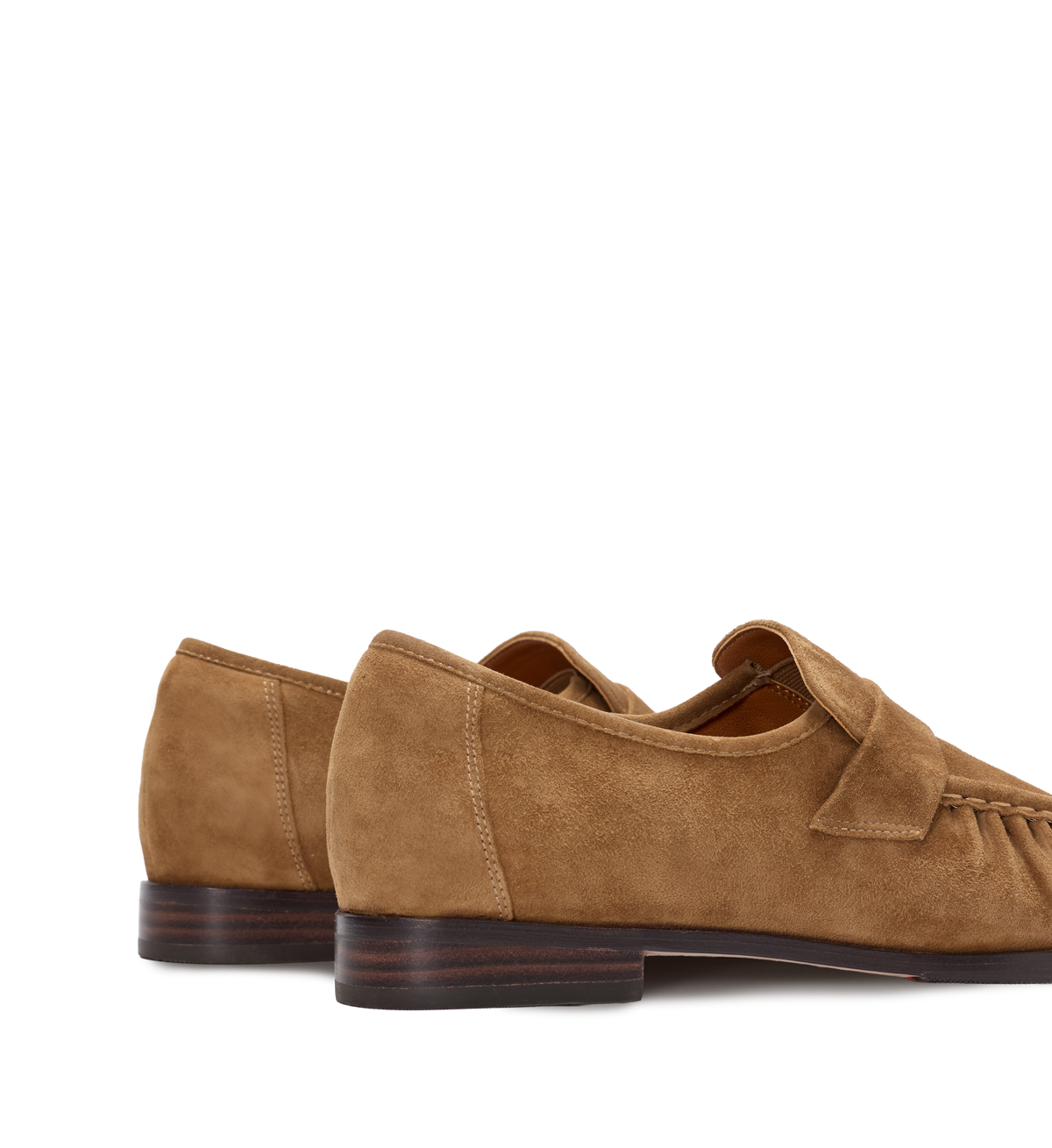 Pair of brown suede loafers on a white background