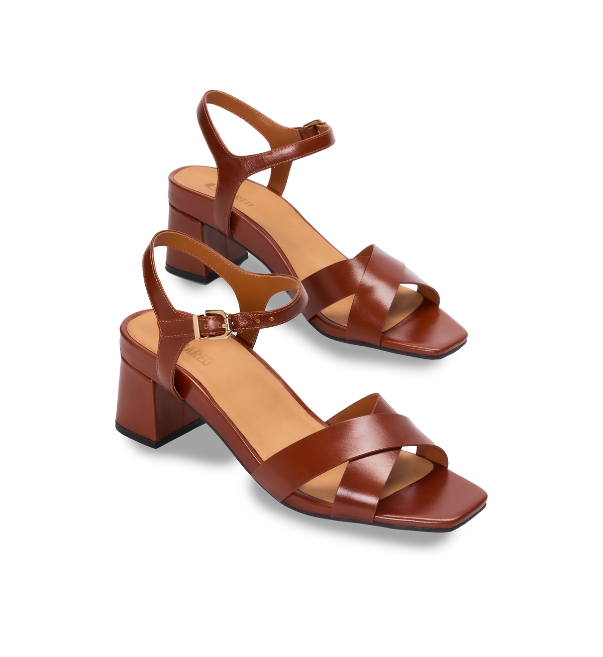 Pair of tan heels on a white background