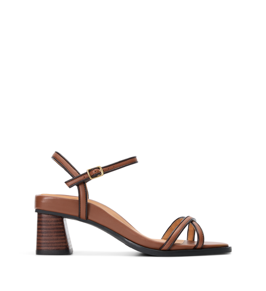 Brown block heel with black contrast detailing on a white background