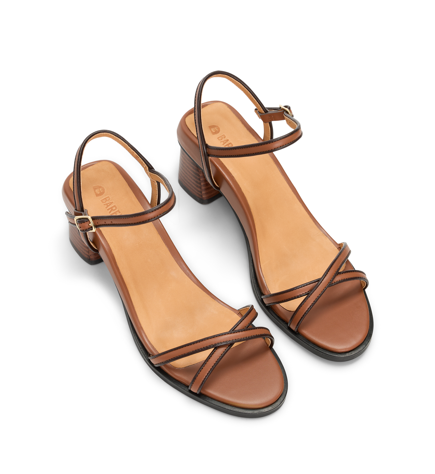 Pair of brown heels with thin straps on a white background