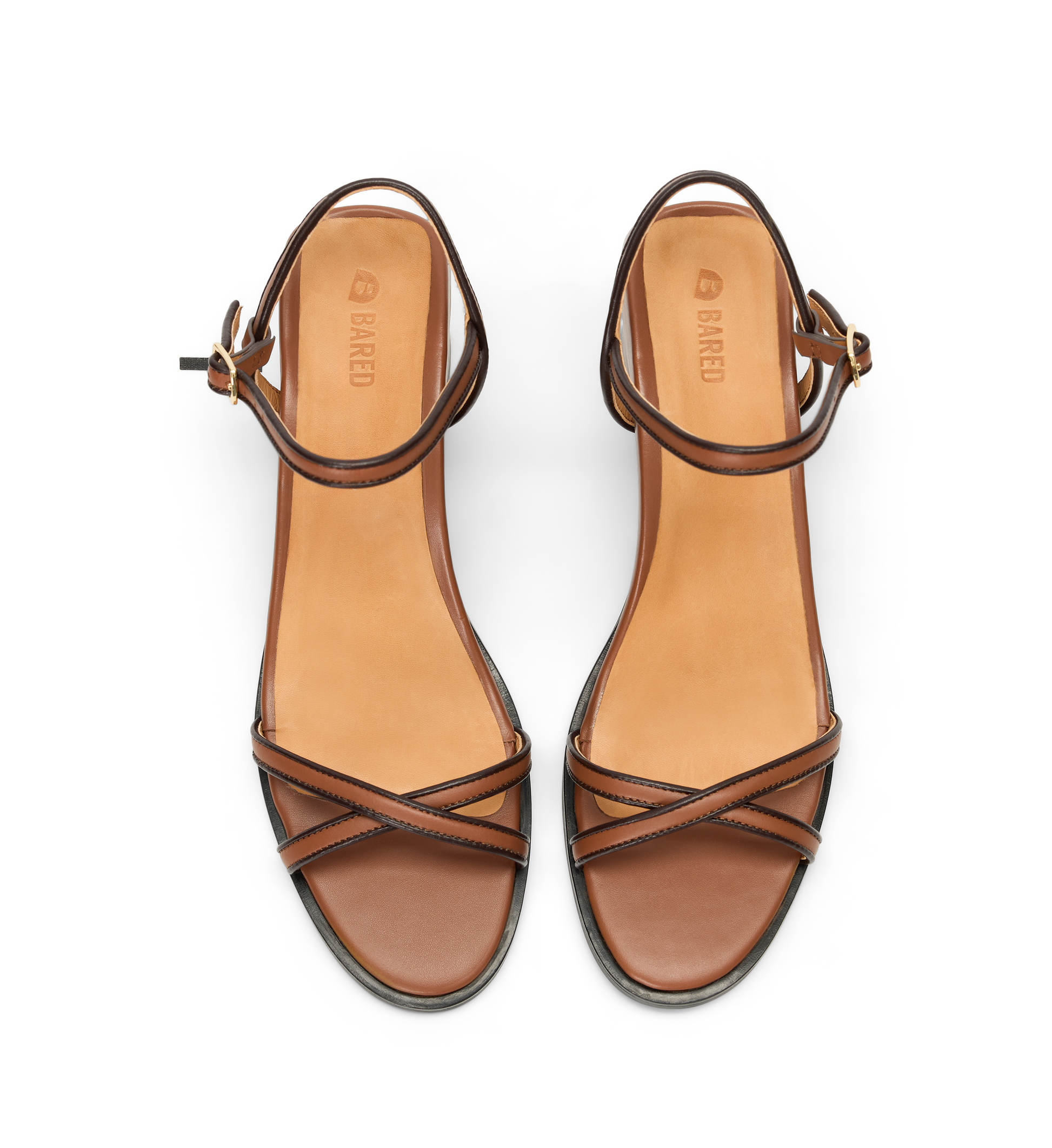 Pair of brown strappy heels on a white background