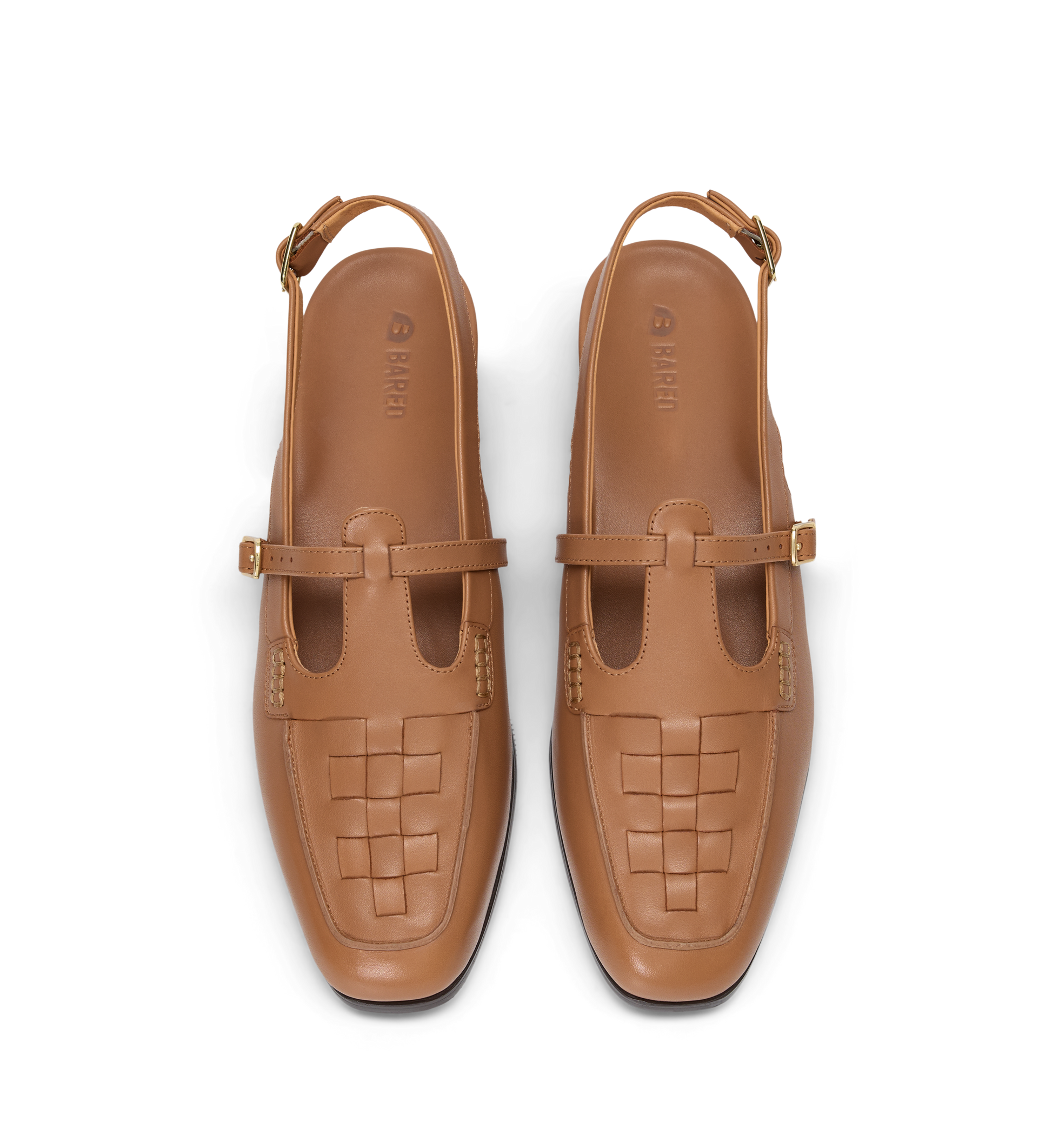 Pair of tan woven shoes with strap details on a white background