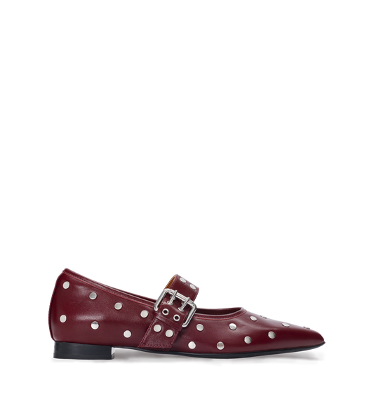 Maroon polka dot ballet flat with a buckle on a white background