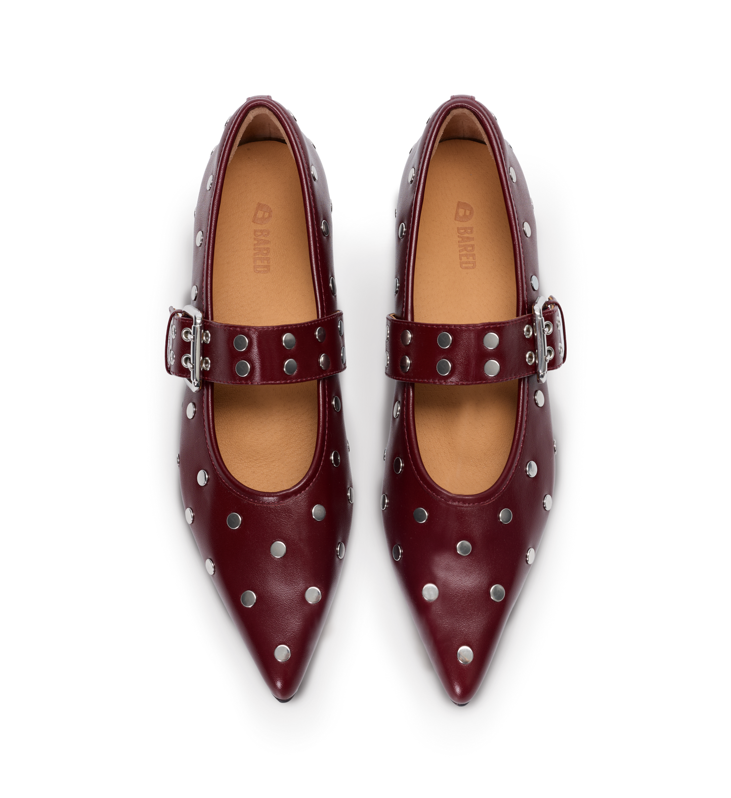 Pair of studded red ballet flats with buckles on a white background