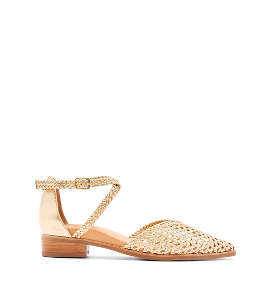 A gold leather sandal with a pointed toe and ankle strap, featuring a low heel and hardware in gold color.