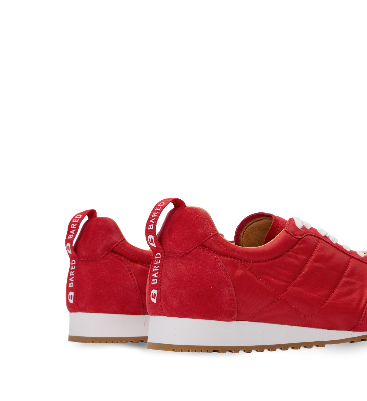 Womens Red sneakers with white soles on a white background