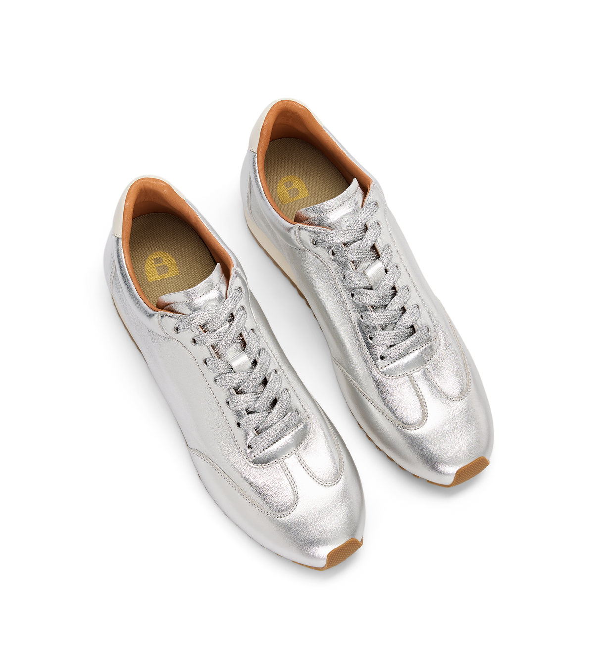 Silver sneakers with brown accents on a white background