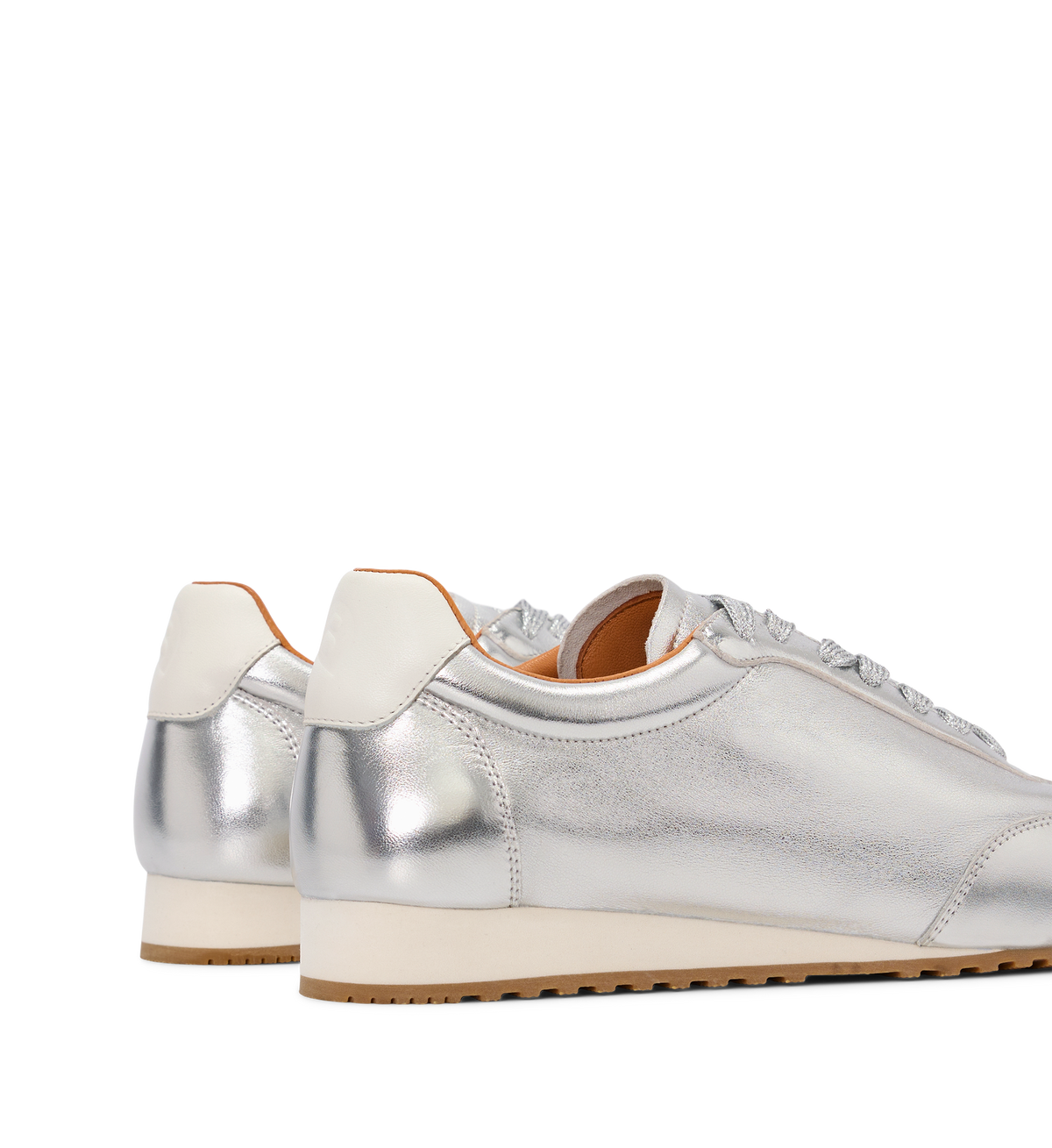 Silver sneakers with white soles on a white background