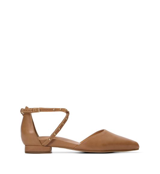Tan flat shoe with a thin strap on a white background