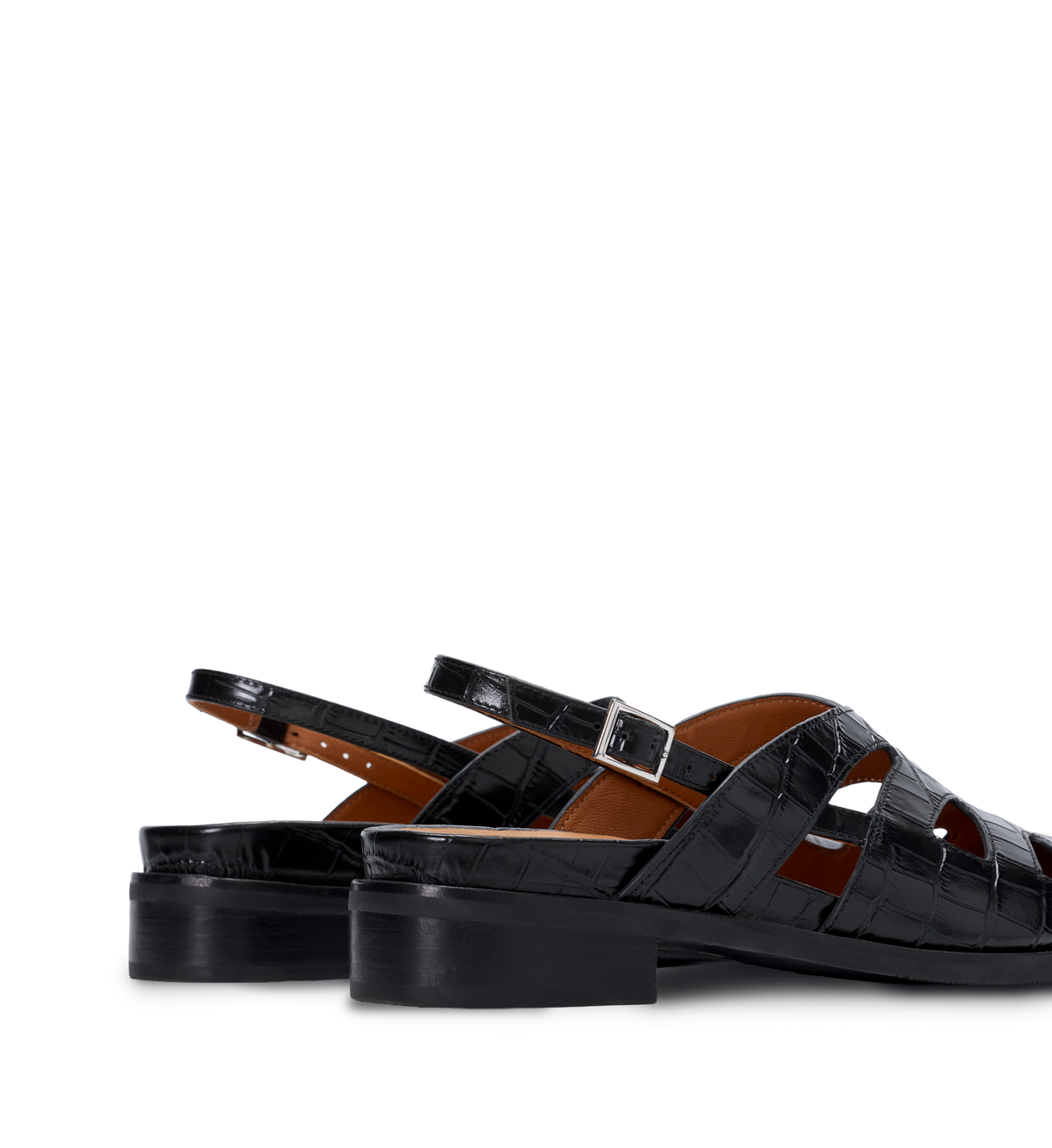 Crocodile-patterned black flats on a white background