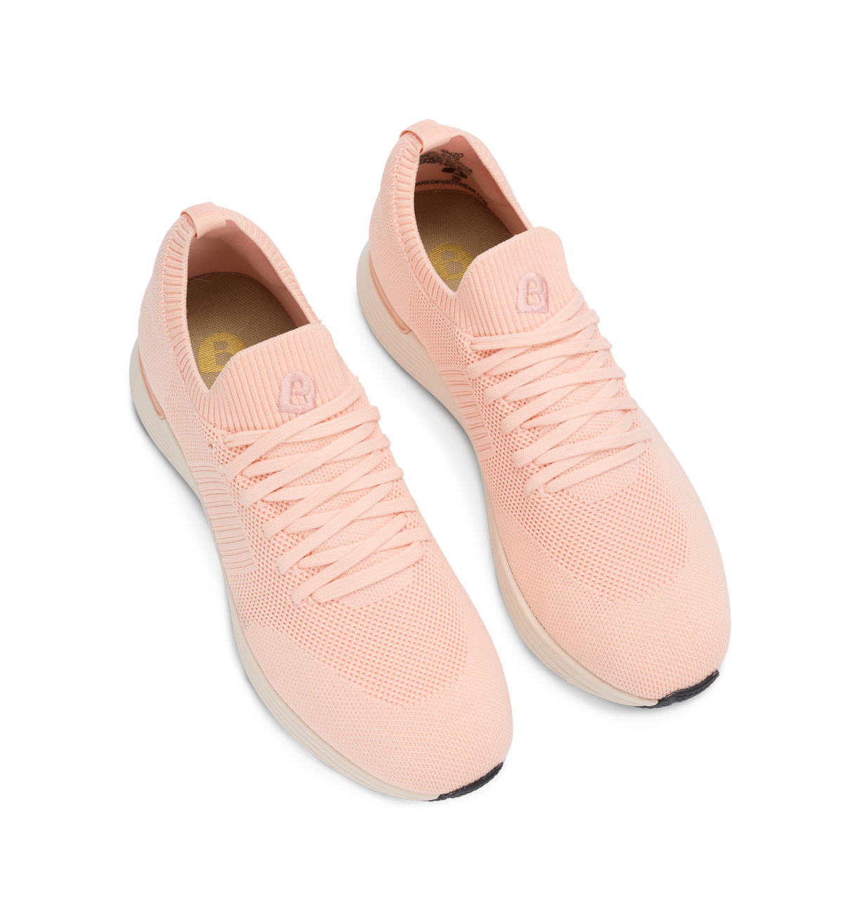 Pair of pink slip-on sneakers on a white background