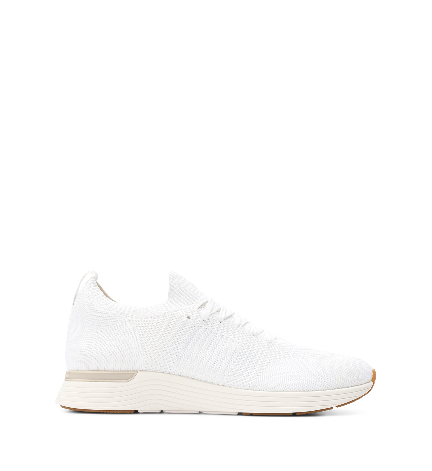 A white knit sneaker with a low-profile silhouette and a lightweight rubber sole.