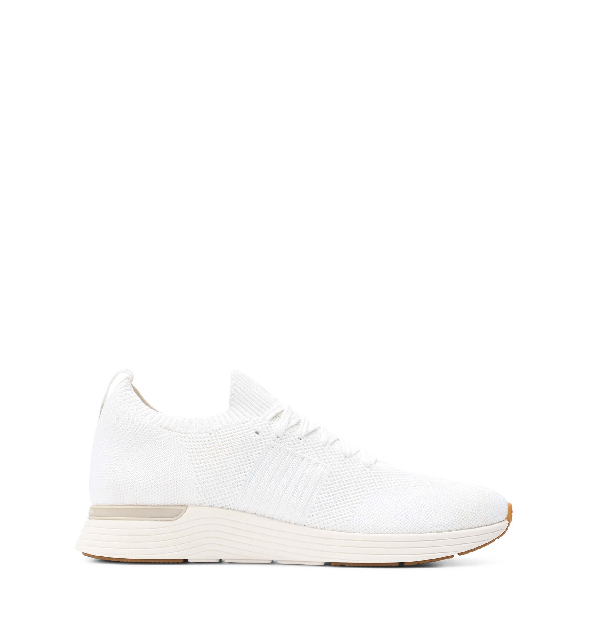 A white knit sneaker with a low-profile silhouette and a lightweight rubber sole.