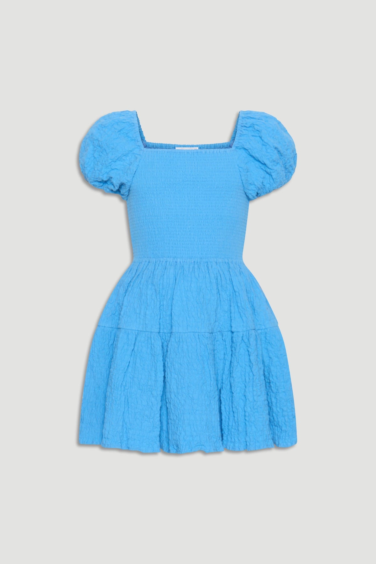 Bright blue girls mini dress with puffed sleeves, smocked bodice, and textured tiered skirt for playful style.