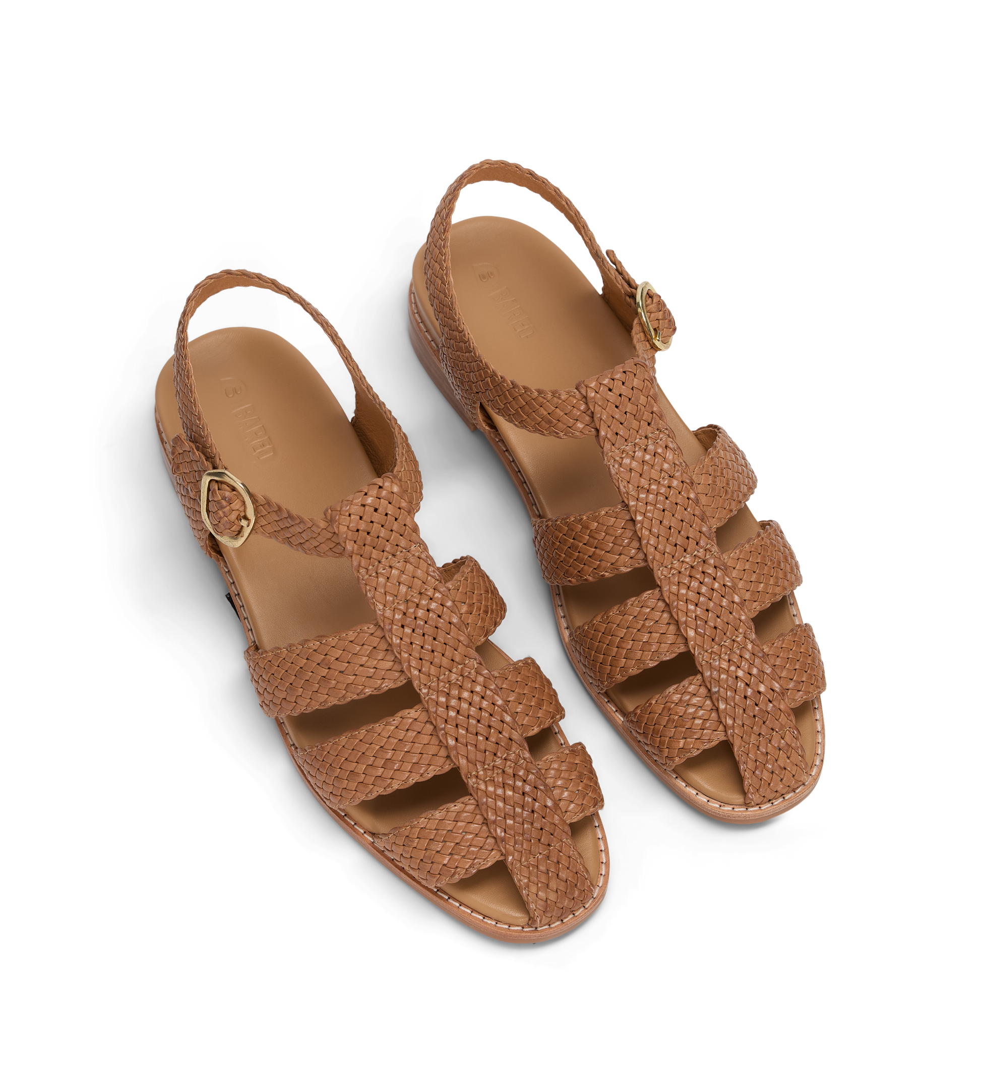 Pair of brown woven sandals on a white background